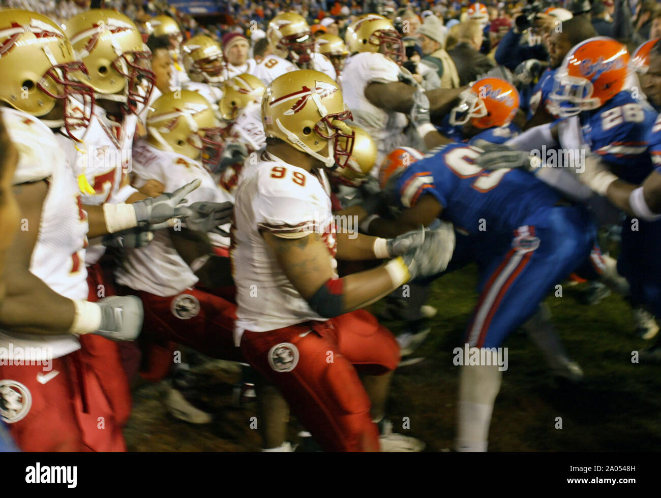 Members of the Florida and Florida State football teams, including Florida State's Travis Johnson (#99), center, fight following the Seminole's 38-34 victory over the Gators Saturday, November 29, 2003. Stock Photo