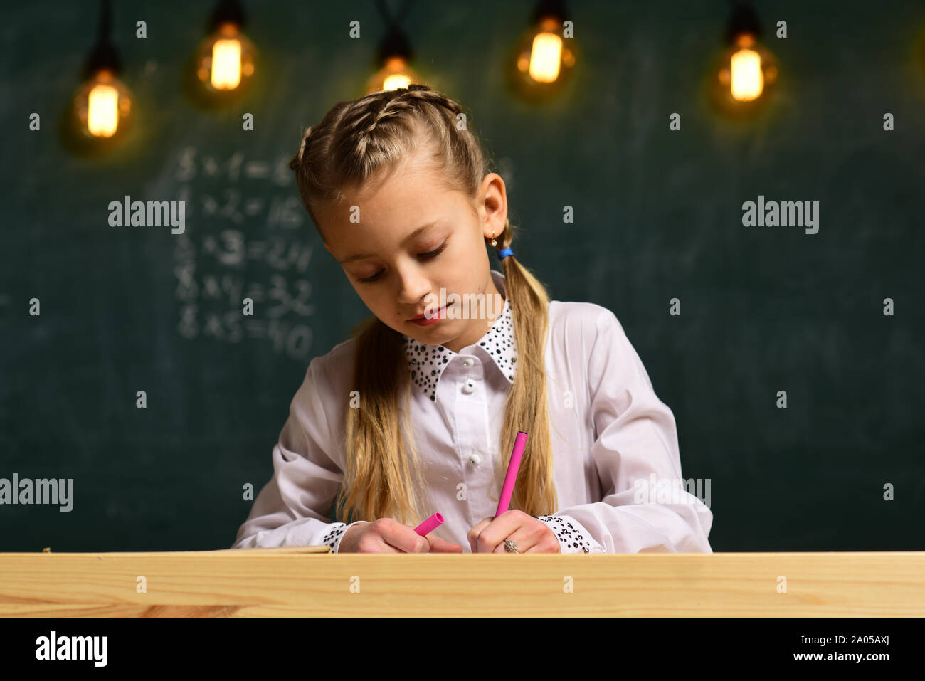 High school or college students studying and reading together in ...