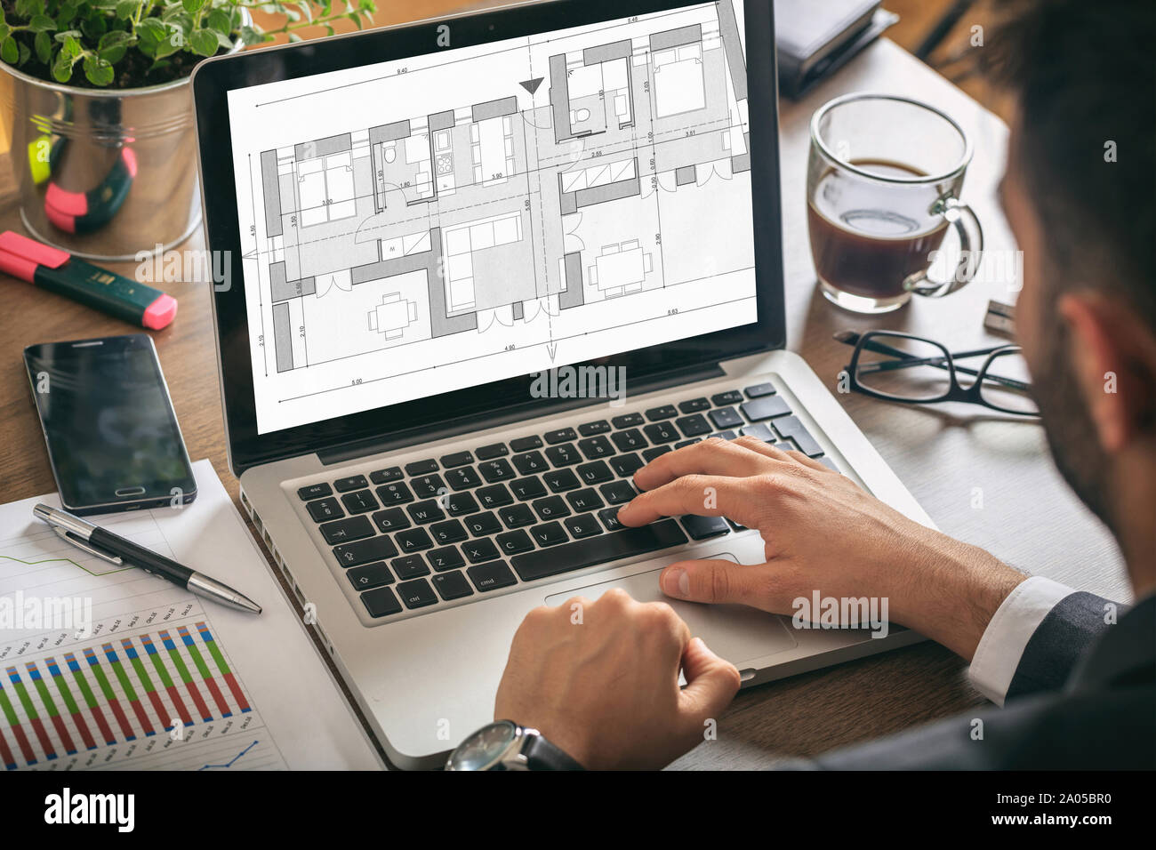 Architect designer working, Building project blueprint plan on a ...
