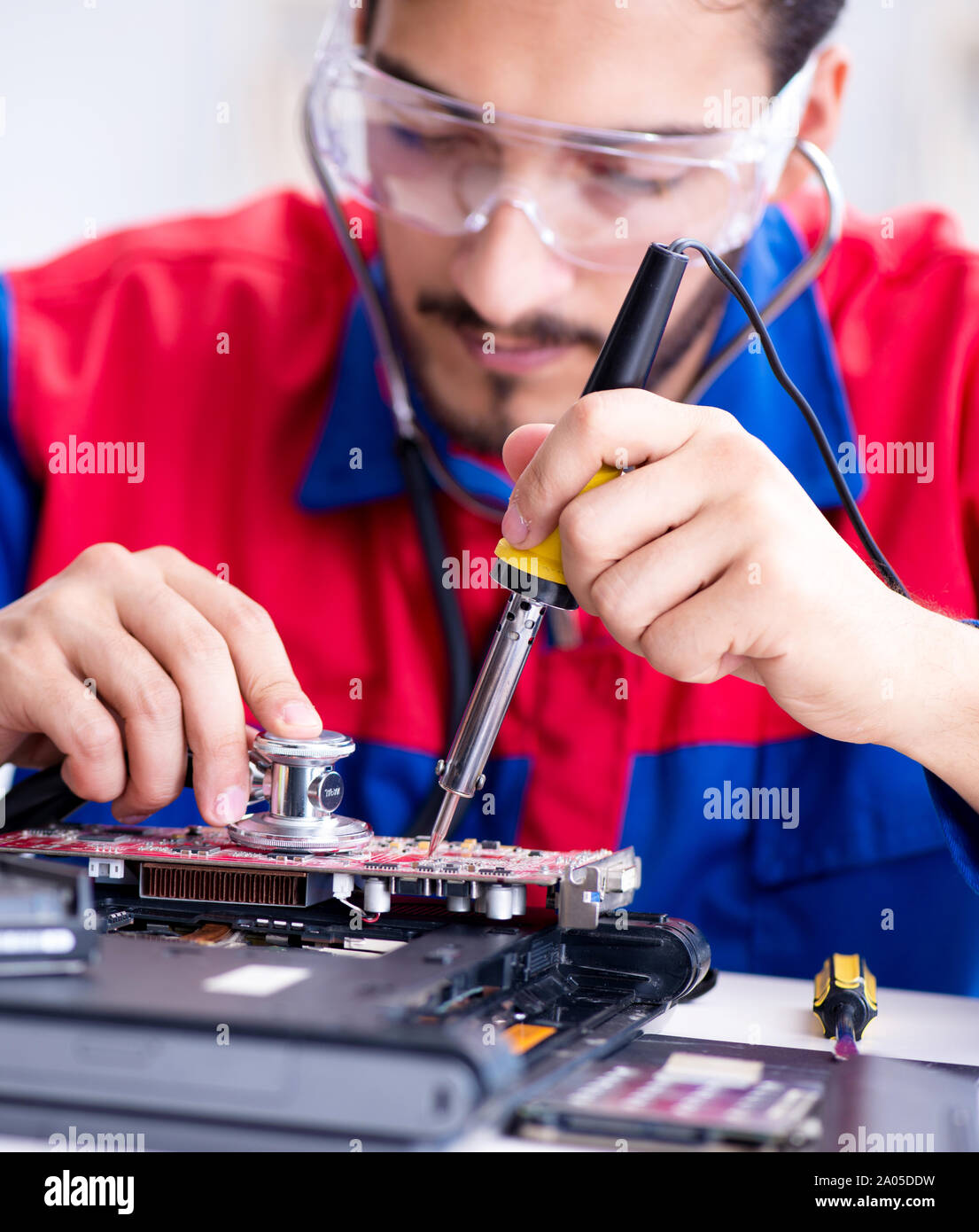 Repairman working in technical support fixing computer laptop