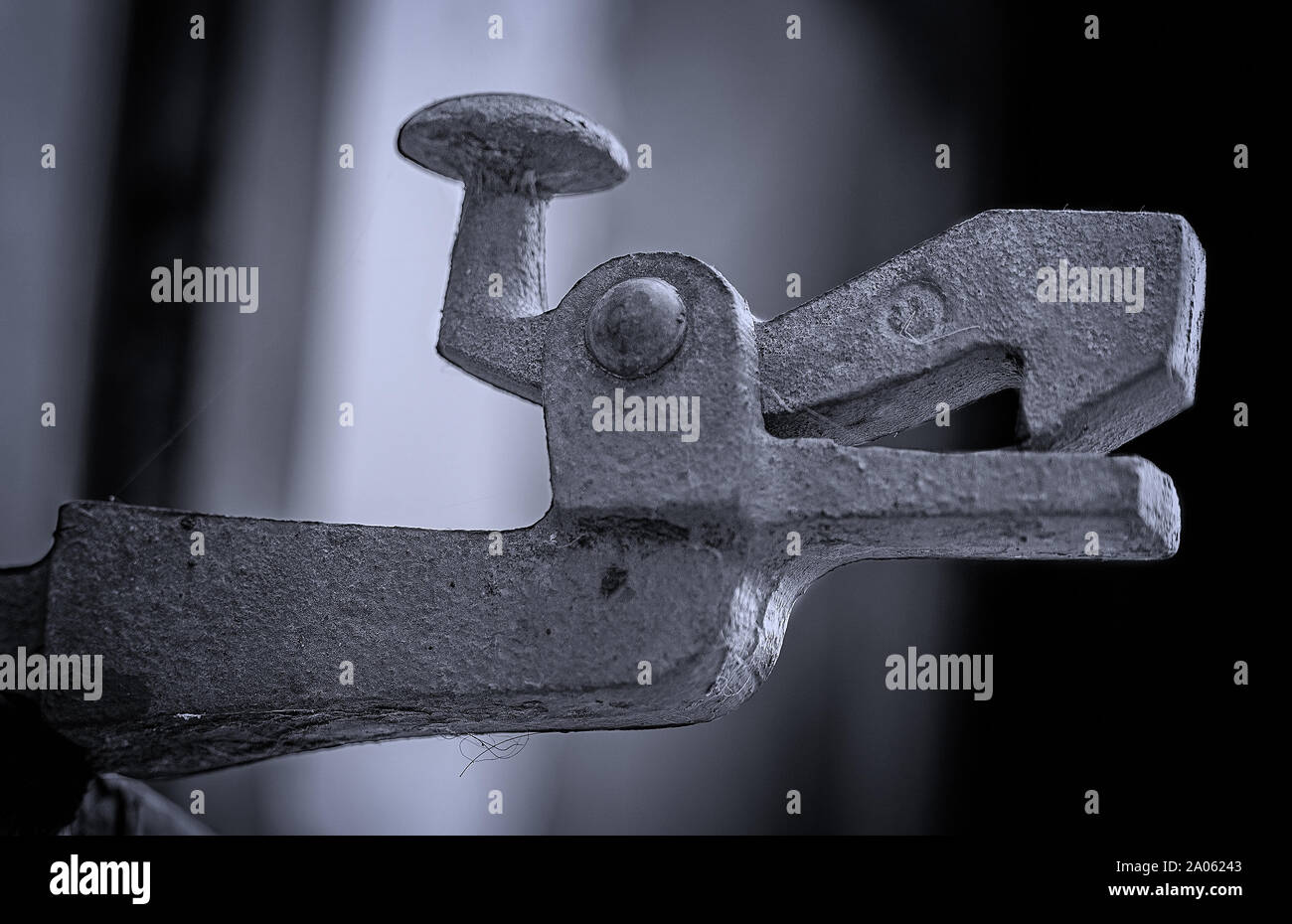 Old metal clamp attached to a wall outside a German industrial building with animal features Stock Photo