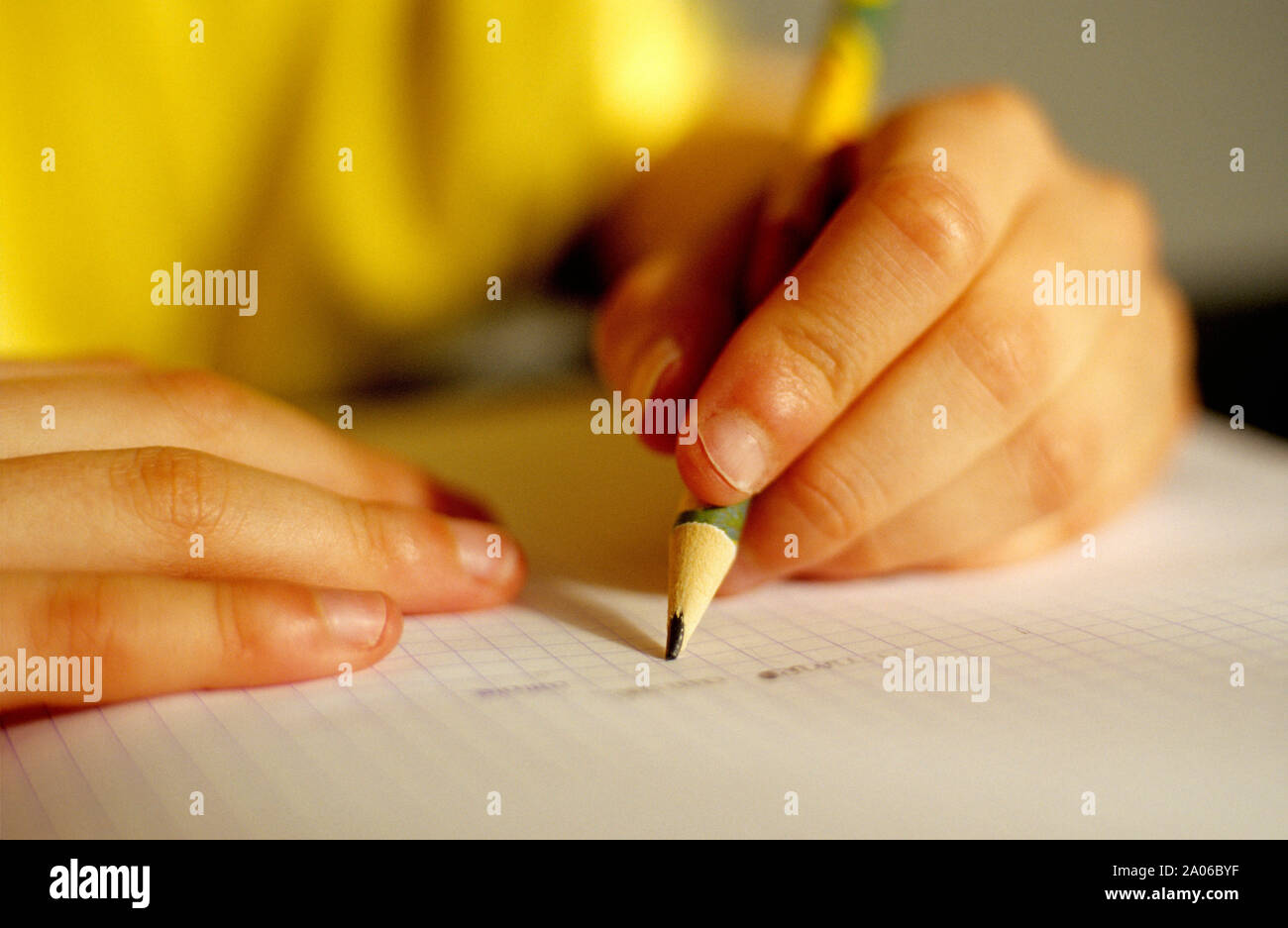 Hands of pupil left handed doing homework Stock Photo