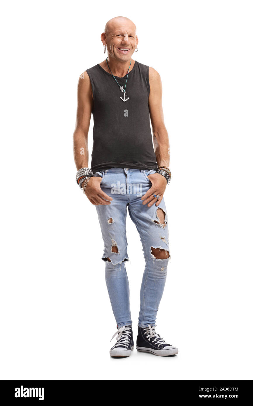 Full length portrait of a smiling bold man with ripped jeans and earings isolated on white background Stock Photo