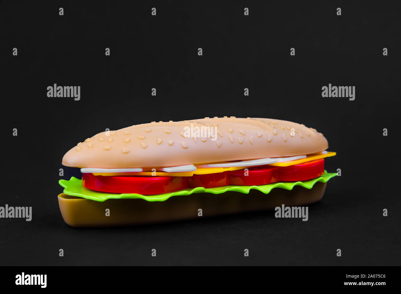 fast food. plastic hot dog on a black background Stock Photo Alamy