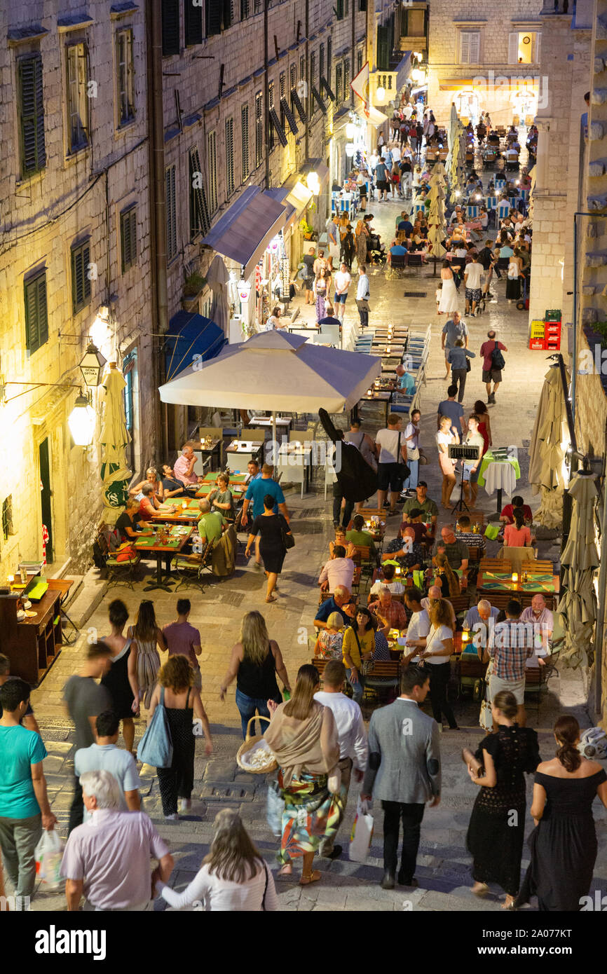 Dubrovnik street - crowds of people in the colourful Gundulic Square in the evening at twilight, Dubrovnik old town, Dubrovnik Croatia Europe Stock Photo