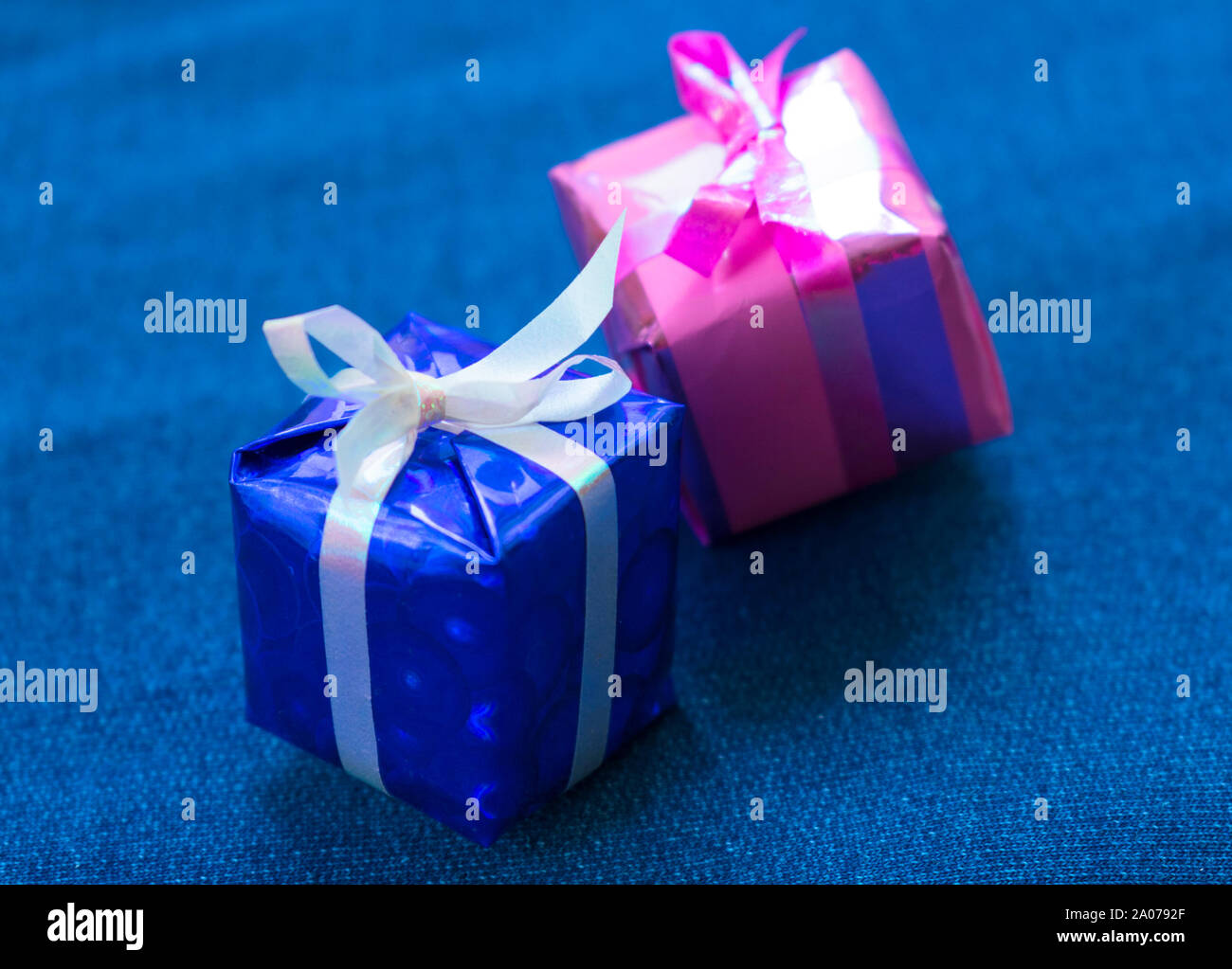 Two small gift decorative boxes on a blue background. Stock Photo