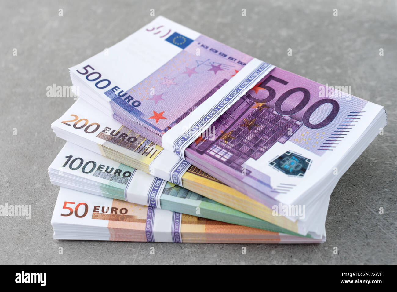 Euro currency money. Cash money, euro bills. Stacks of Euro notes on  concrete background in five hundred, two hundreds, one hundreds and fifties  Stock Photo - Alamy
