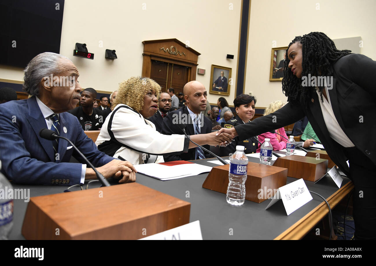 Washington, United States. 19th Sep, 2019. Rep. Ayanna Pressley of Massachusetts (R) shakes hands with Gwen Carr as National Action Network's Rev. Al Sharpton (L) and former tennis player James Blake look on at the House Judiciary Committee, on Capitol Hill, Thursday, September 19, 2019, in Washington, DC. The panel was hearing testimony on police practices and Carr's son Eric Garner died in a police chokehold during an arrest on Staten Island, New York, and Blake was roughed up in a mistaken arrest. Photo by Mike Theiler/ Credit: UPI/Alamy Live News Stock Photo