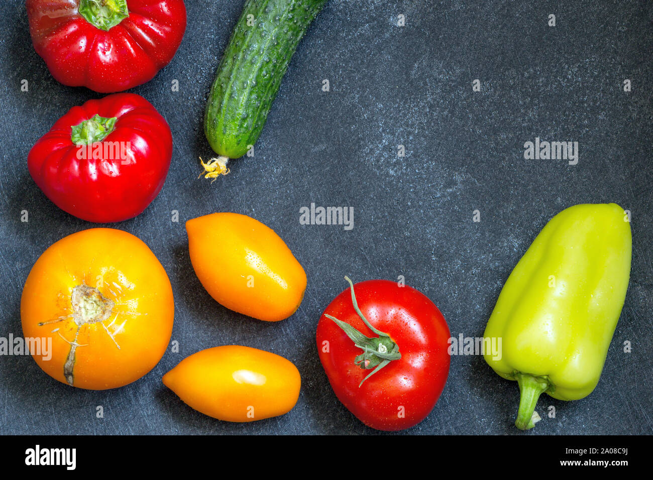 Fresh whole vegetables from new harvest on dark blue background with copy space. Top view. Close-up. Raw foods, healthy meal concept. Vegan diet. Wash Stock Photo