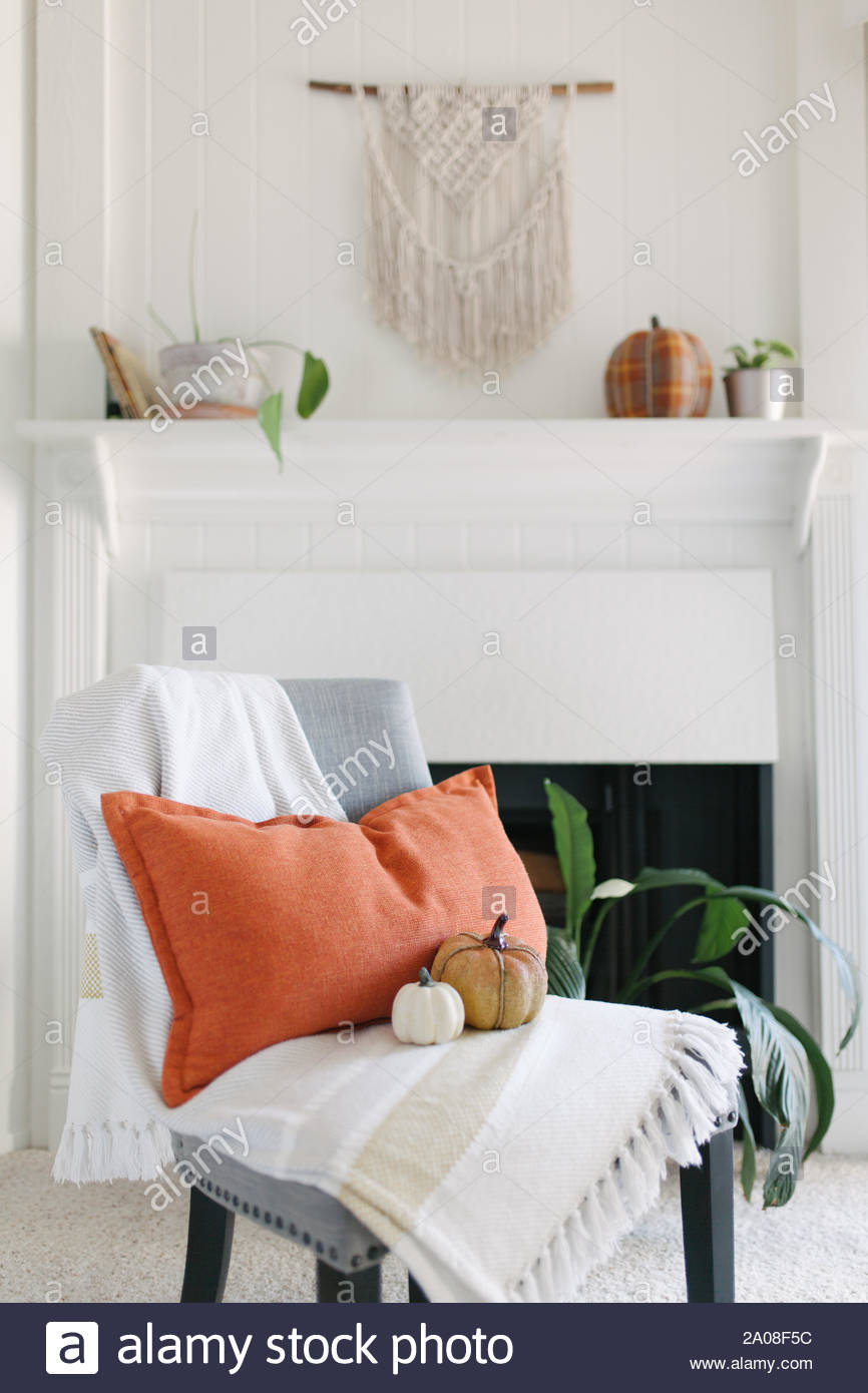 Grey Chair With Striped Throw Orange Accent Pillow And