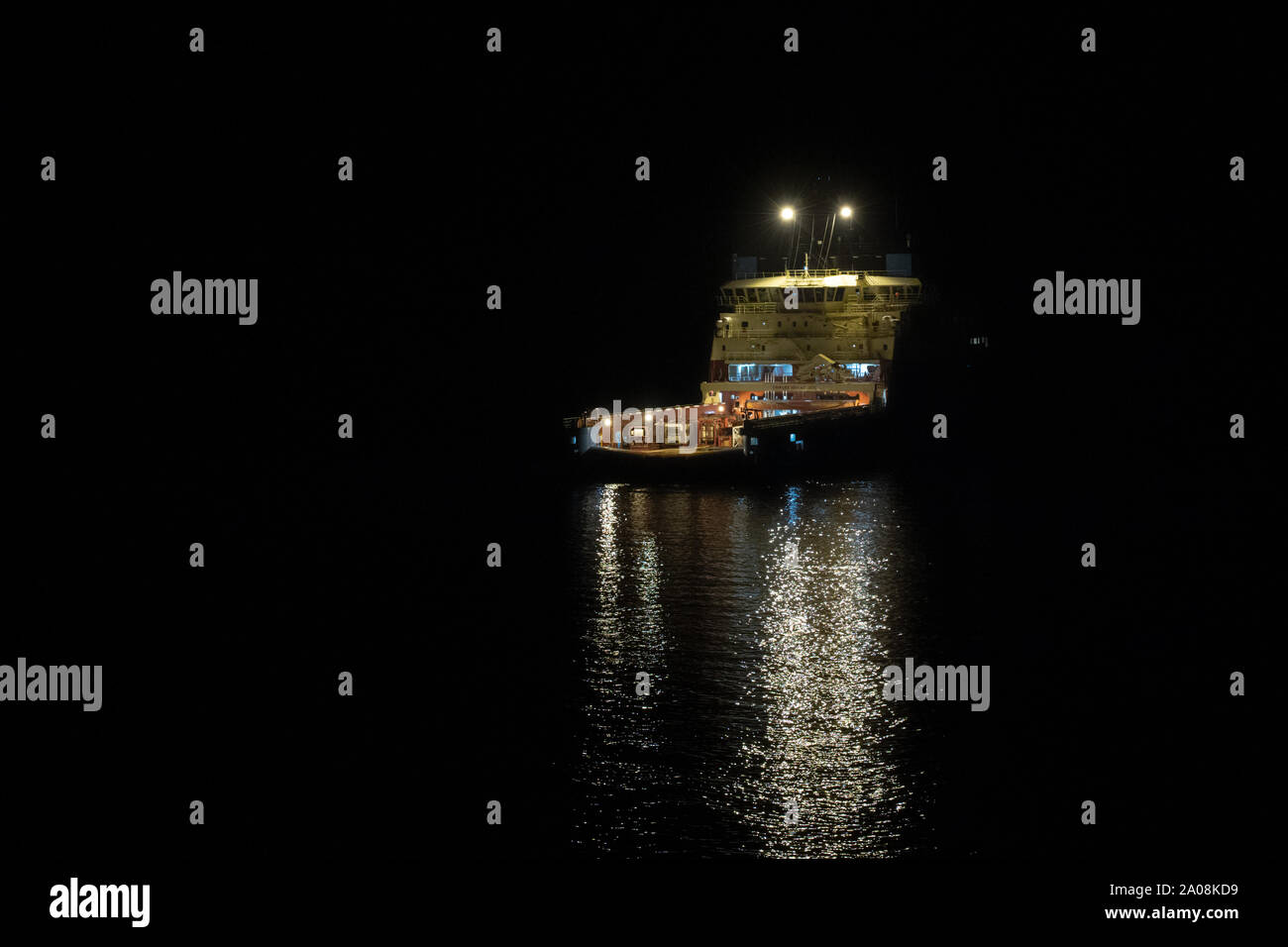 Borneo, Indonesia - July 2019: Maersk owned oil field support vessel standing by on an oil field by night Stock Photo