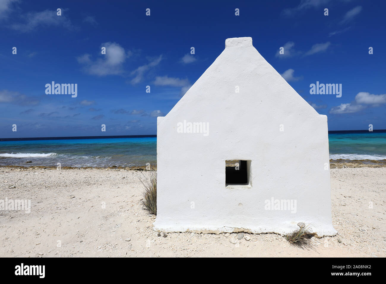 Small white slave hut on Bonaire island in the caribbean sea Stock