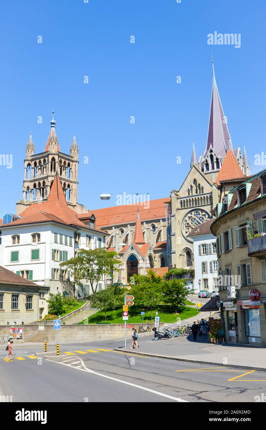 Lausanne, Switzerland - August 11, 2019: The historical old town of the French-speaking Swiss city with medieval Notre Dame Cathedral. People walking on the street. Tourist attractions. Stock Photo