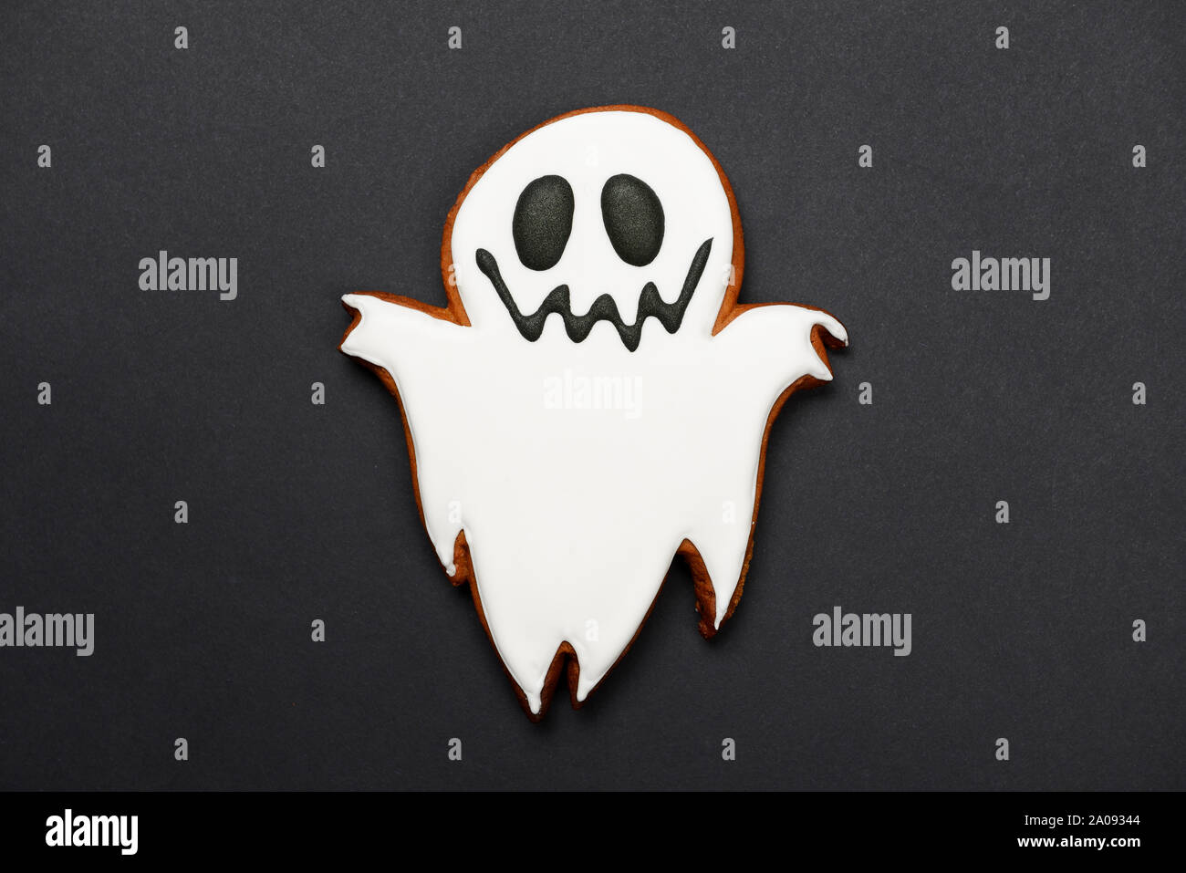The hand-made eatable gingerbread Halloween ghost on black background ...