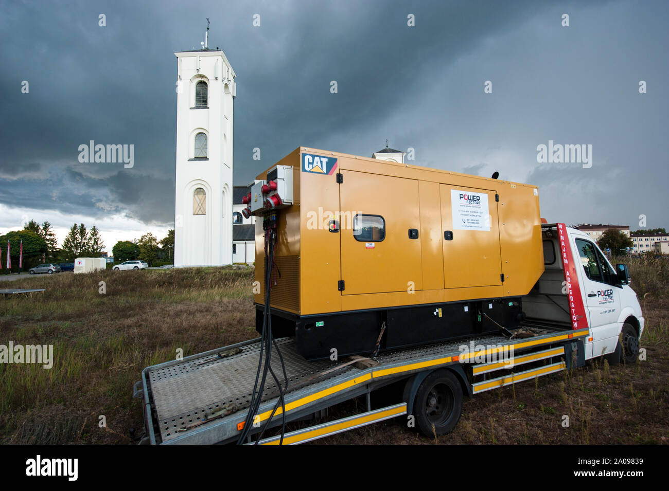 Emergency electric power generator used during stormy weather in Pultusk, Poland, to provide electricity for a community with church and a hospital. Stock Photo