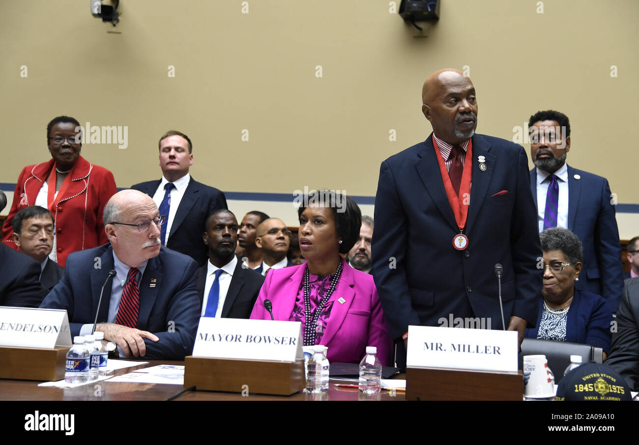 US Navy Veteran and District of Columbia resident Kerwin Miller (R) requests attendees to stand in support as he makes remarks  before the House Oversight and Reform Committee, as DC City Council Chairman Phil Mendelson (L) and Mayor Muriel Bowser listen, on Capitol Hill, Thursday, September 19, 2019, in Washington, DC. The panel was hearing testimony on HR51, legislation to admit The District as the 51st state to the Union.         Photo by Mike Theiler/UPI Stock Photo