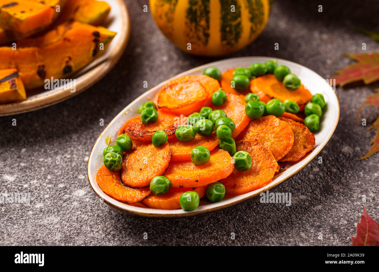 Glazed roasted carrot with peas Stock Photo Alamy