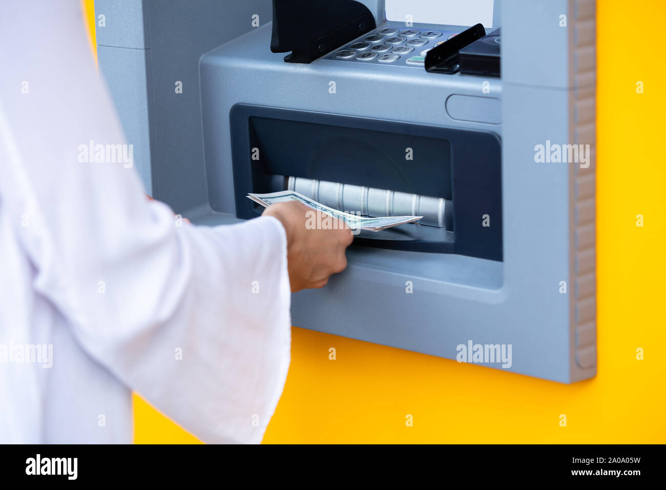 Close-up Of A Woman's Hand Holding Cash Withdraw From Automatic Teller Machine Stock Photo