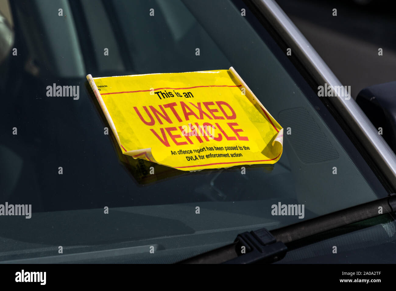 UK Untaxed Vehicle sticker on the windscreen of a parked car Stock Photo