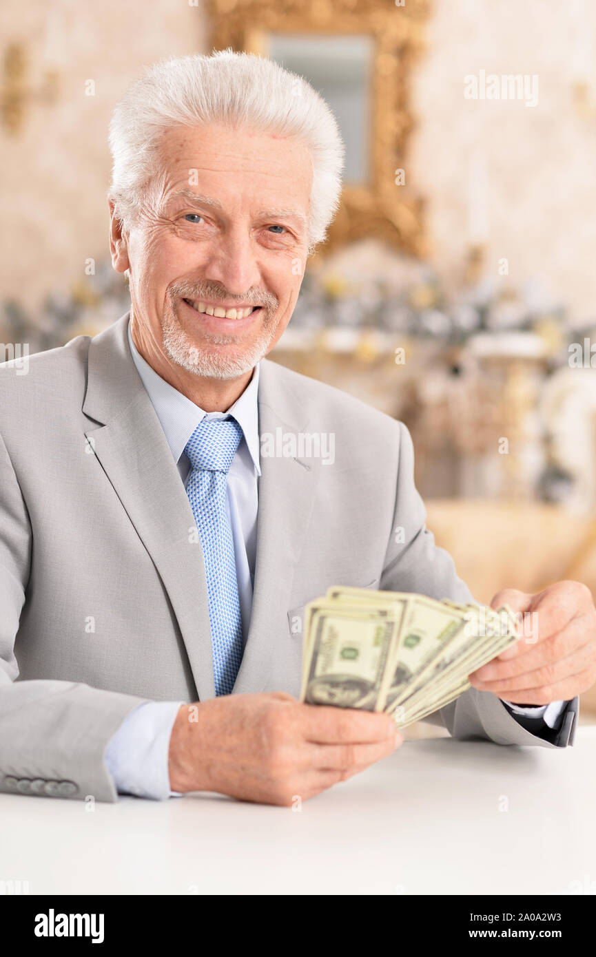 Portrait of a confident senior businessman counting money Stock Photo ...
