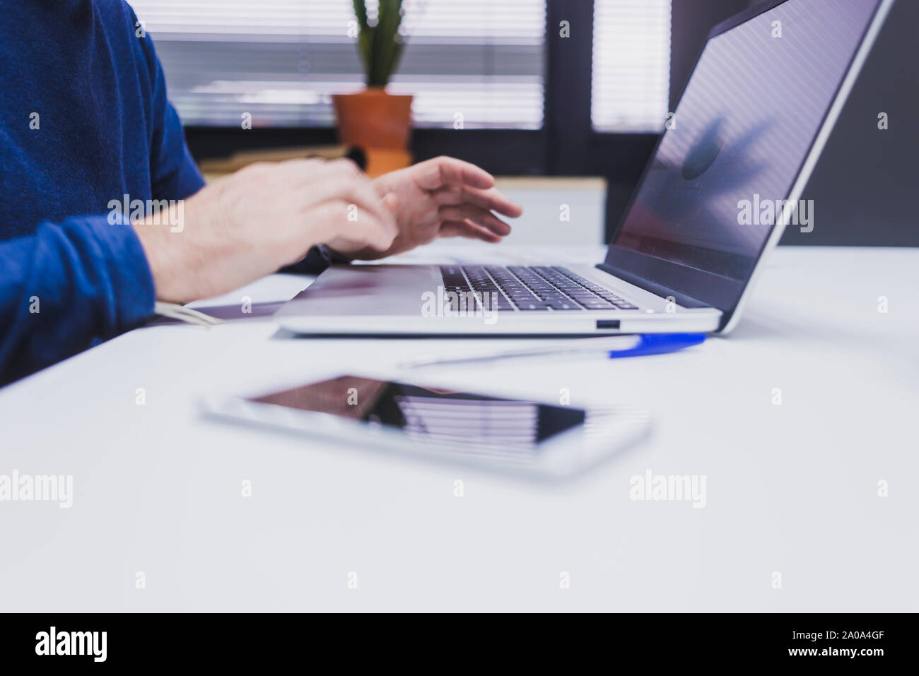 Anonymous man typing on laptop at office. Stock Photo