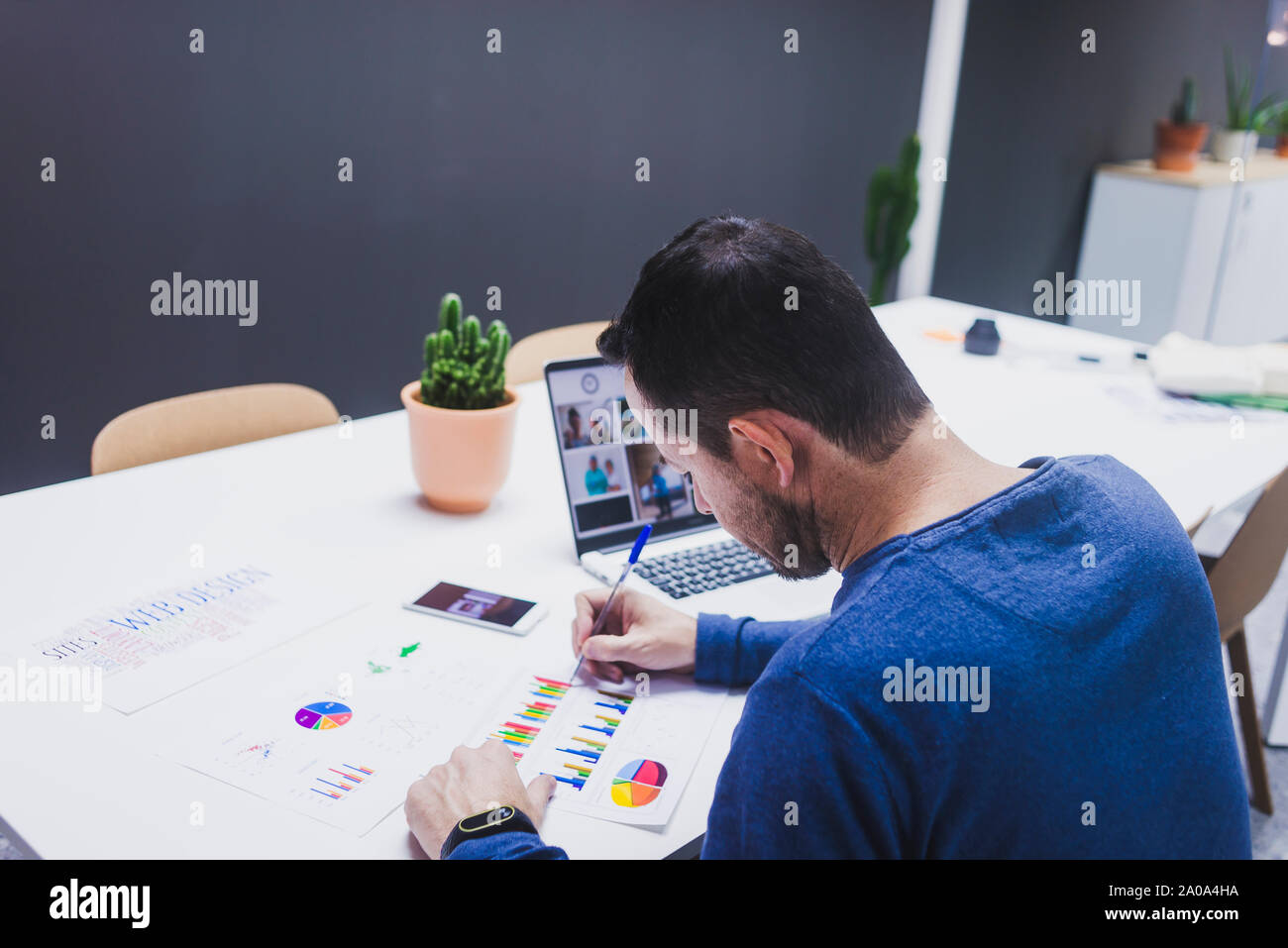 Man working on documents at desk in office Stock Photo