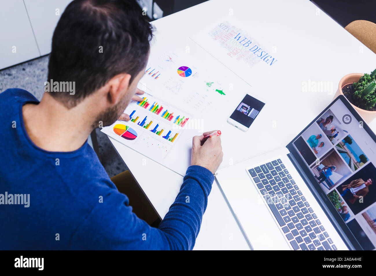 Man working on documents at desk in office Stock Photo