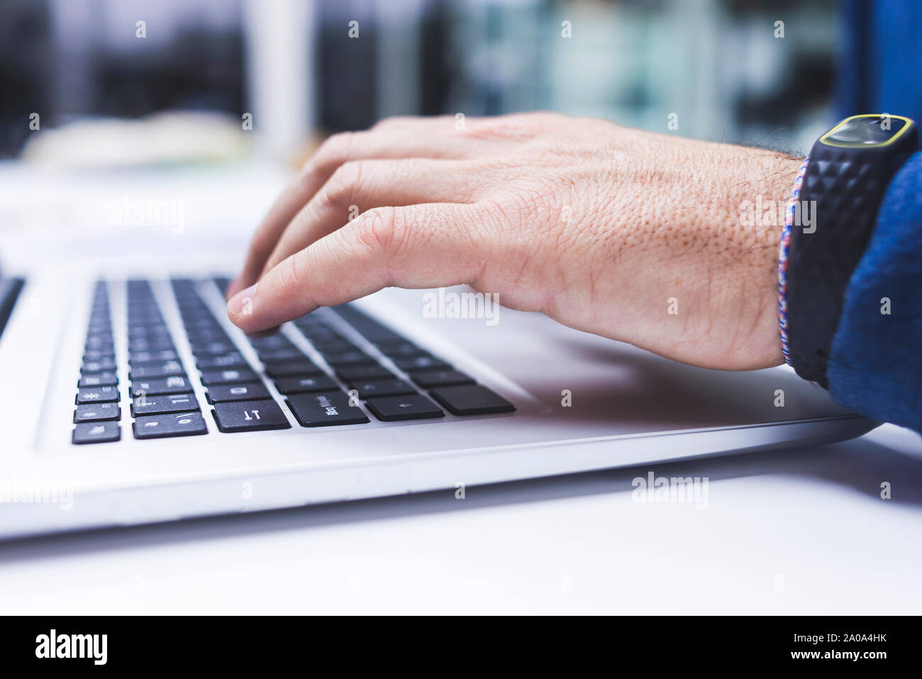 Anonymous man typing on laptop at office. Stock Photo