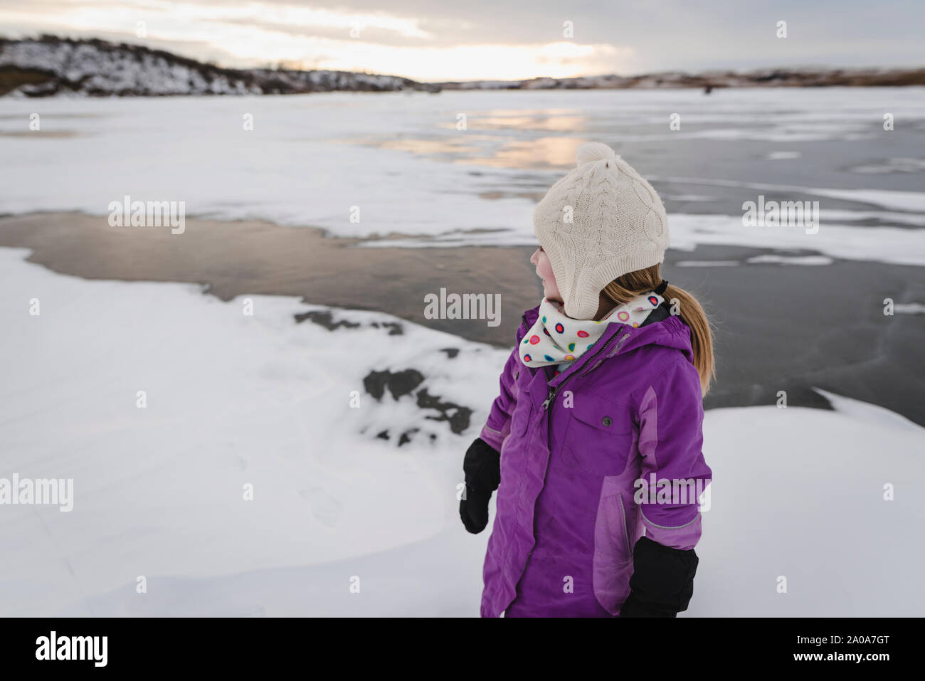 Little Girl Plays on Frozen Lake Stock Photo