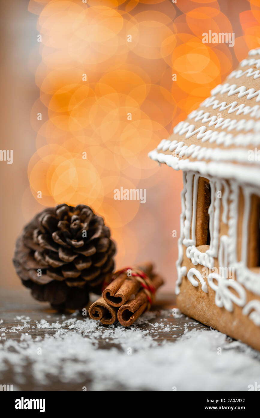 Cinnamon and christmas decoration on wooden table. Spruce branch and snow. Morning in the bright living room. Holiday mood. Stock Photo