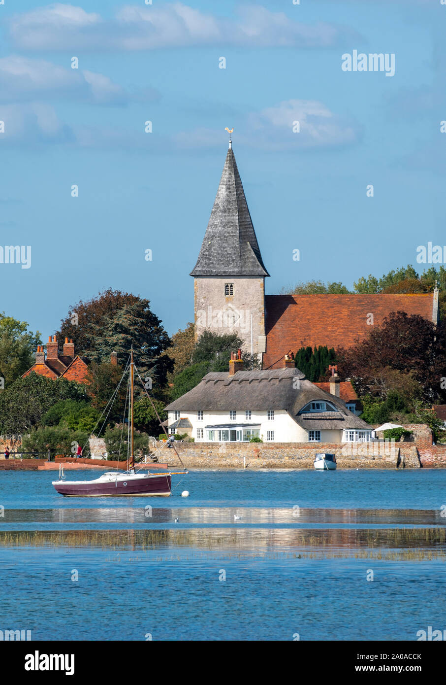 High tide in the picturesque village of Bosham showing the Holy Trinity Church,  Chichester Harbour, West Sussex, England, UK Stock Photo