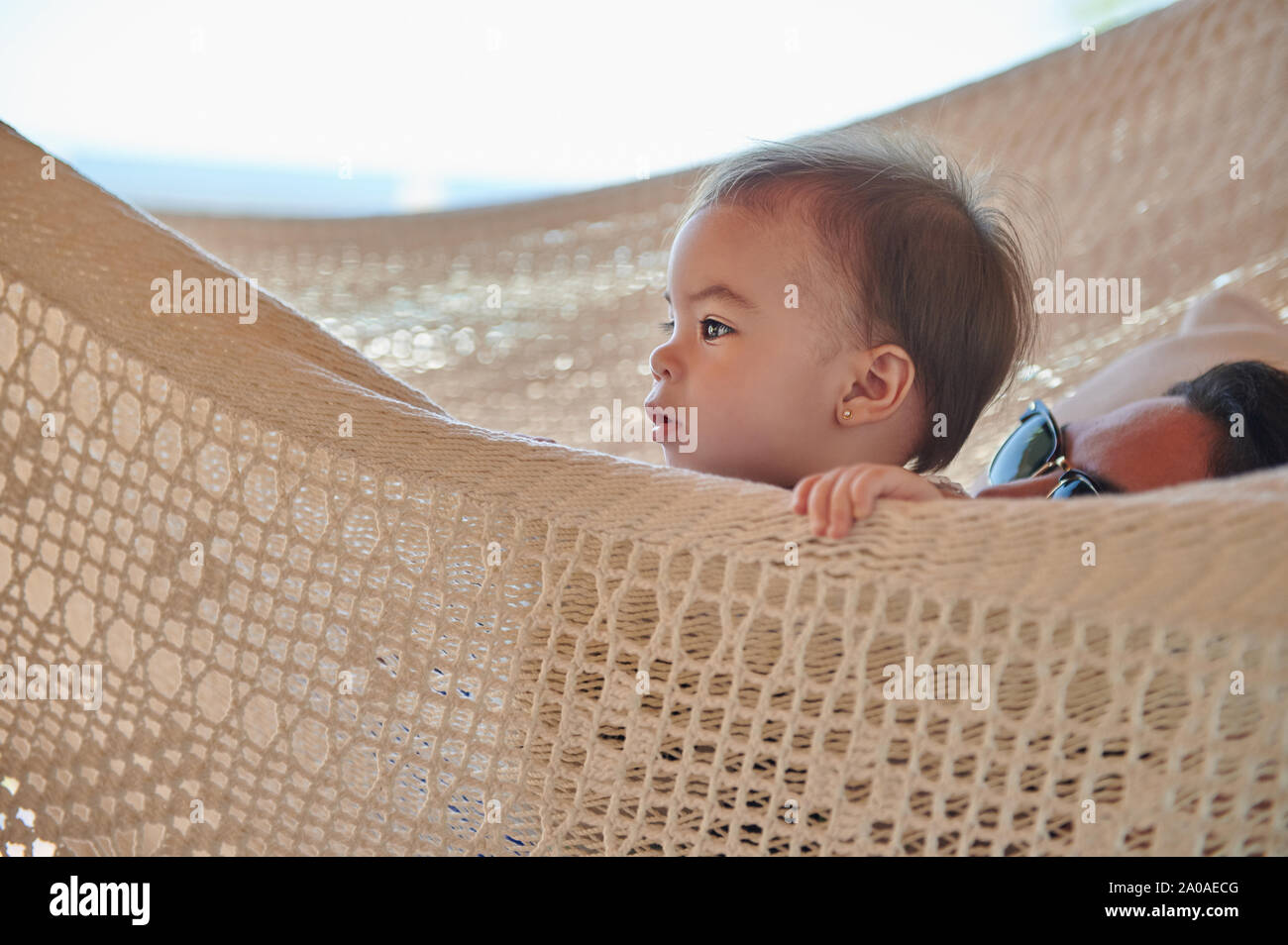 Baby and mom in hammock lay on vacation Stock Photo