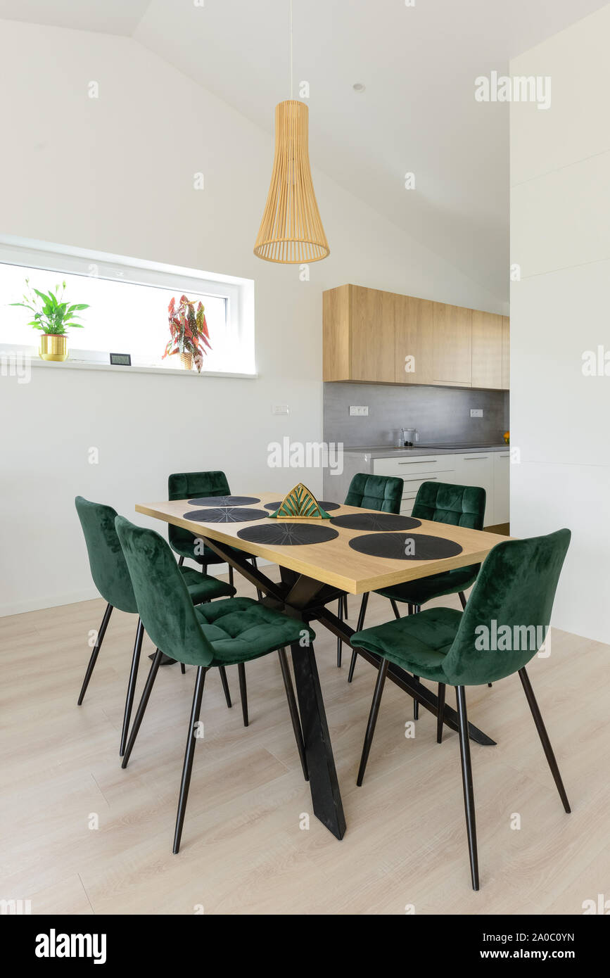 Dining table next to kitchen in contemporary house Stock Photo Alamy
