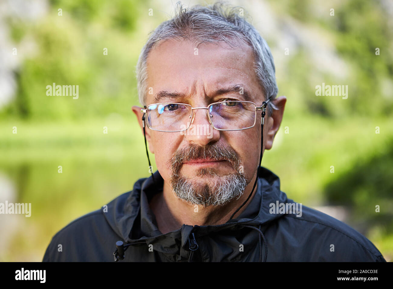 A Close Up Portrait Of An Intelligent Elderly Man With A Serious
