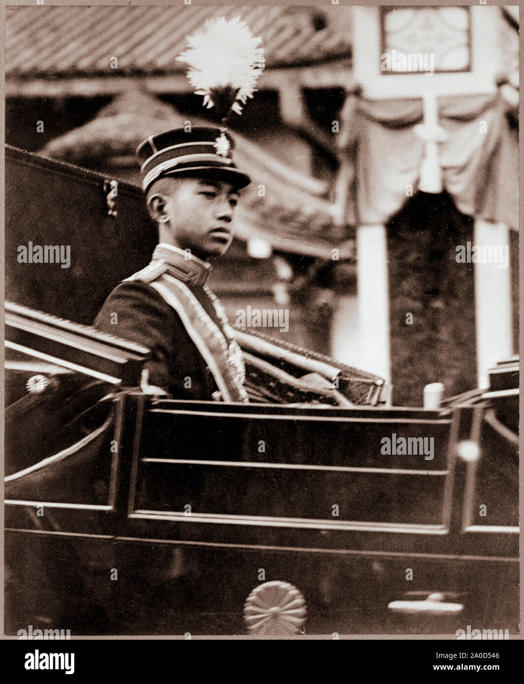 Hirohito, Emperor of Japan, wearing Japanese military uniform, half-length portrait, facing right, seated in carriage with chrysanthemum emblem on the door. Stock Photo