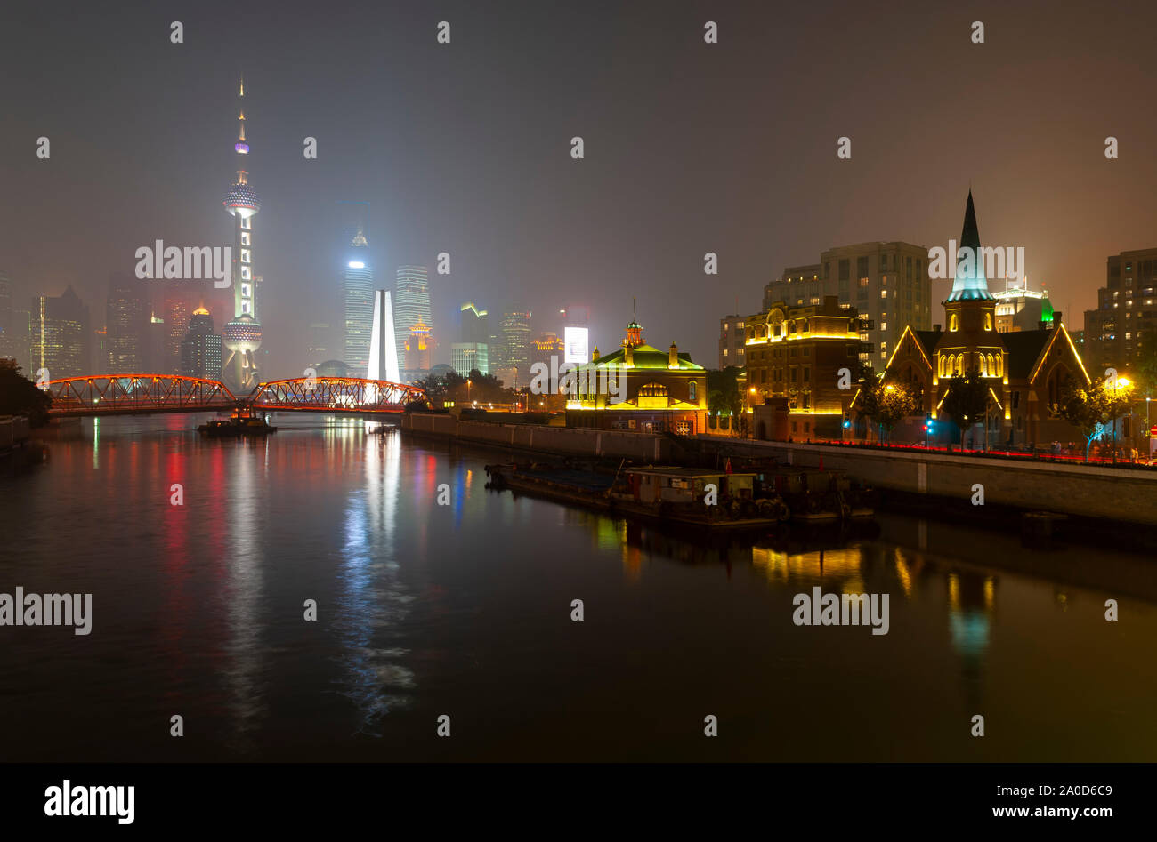 The skyline of Shanghai by night with its skyscrapers and the Former Union Church in the fog near The Bund, Shanghai, China. Stock Photo