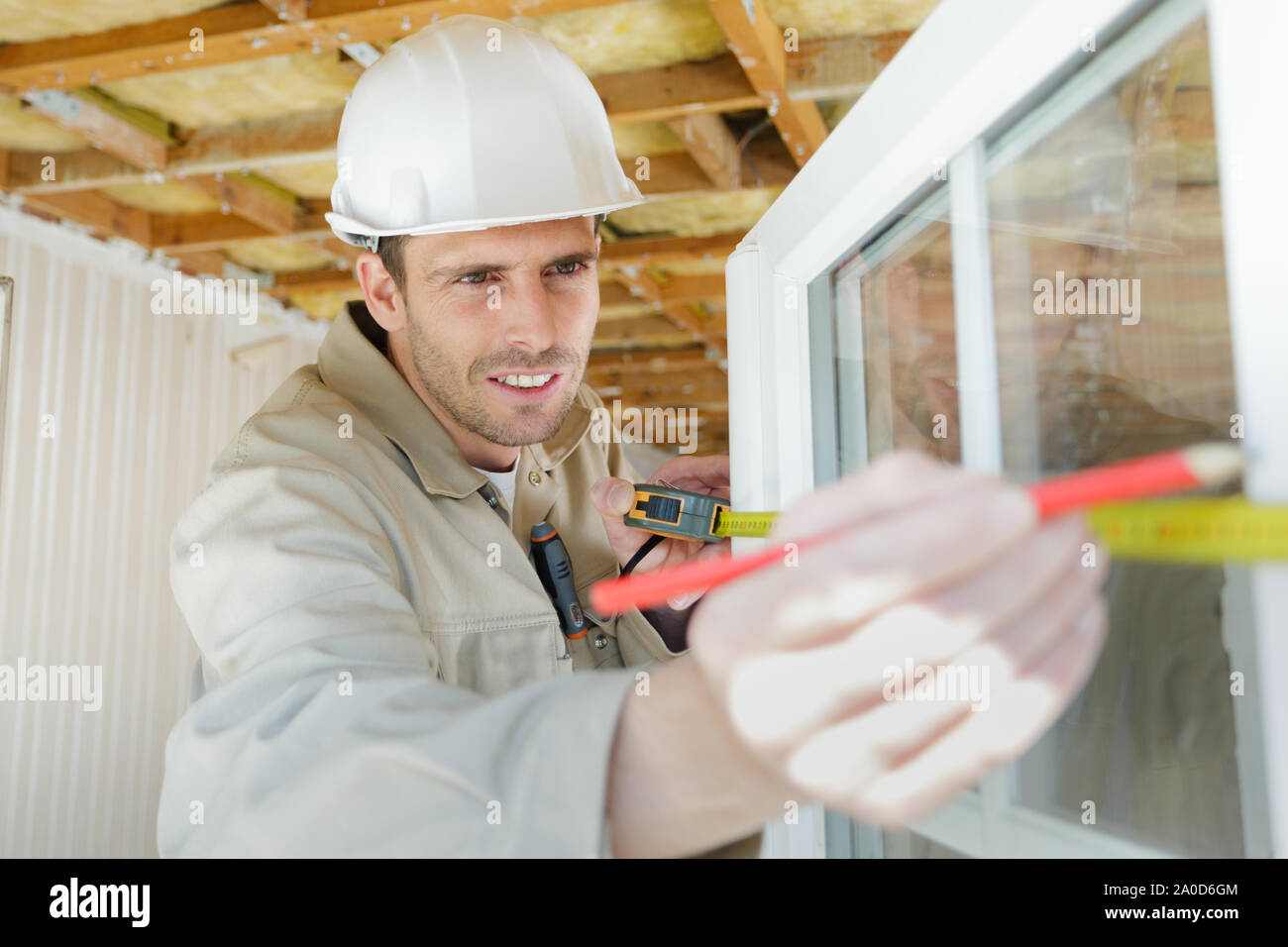 male builder measuring double-glazed window Stock Photo
