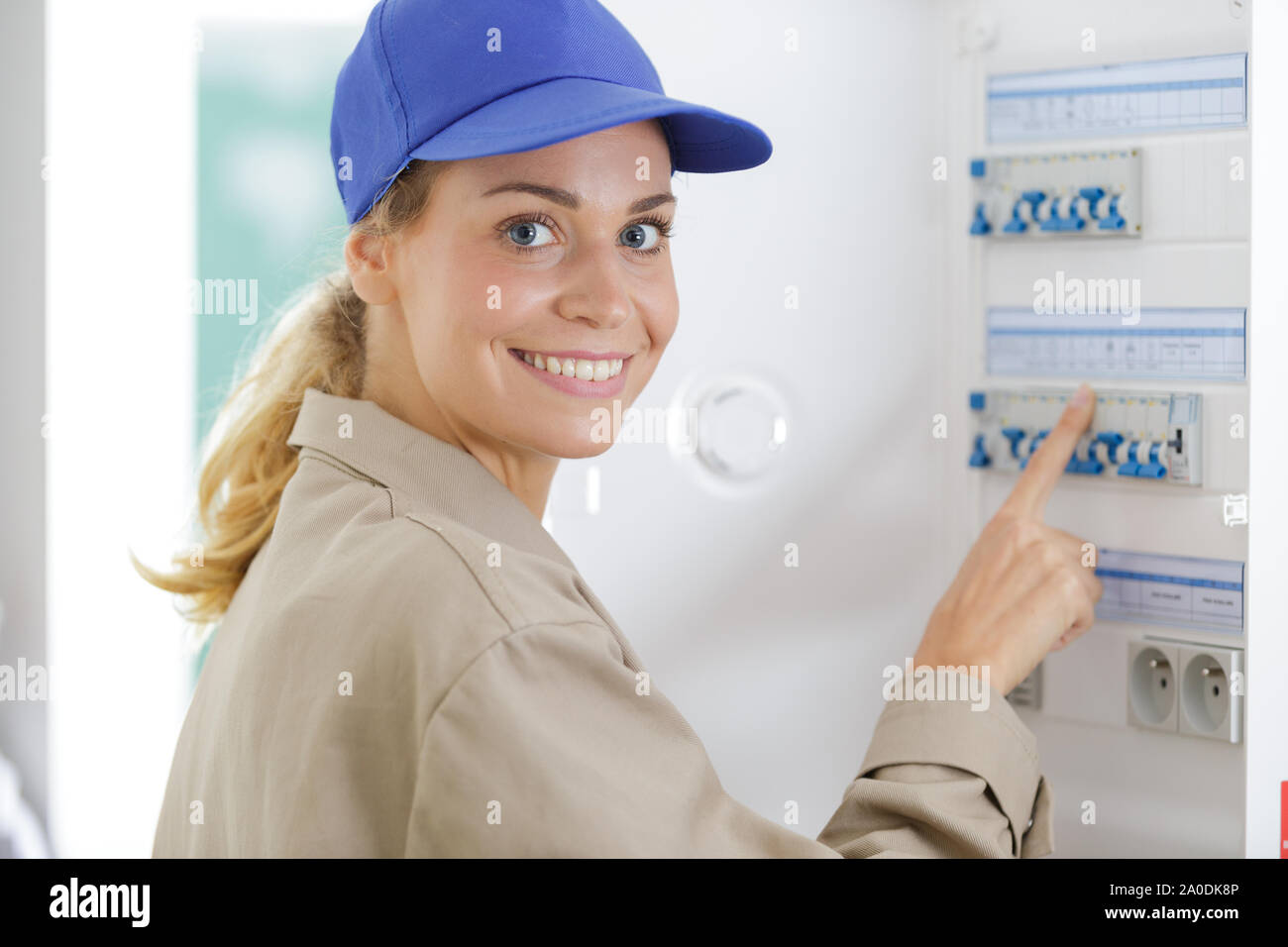 female worker inspecting fuse board Stock Photo