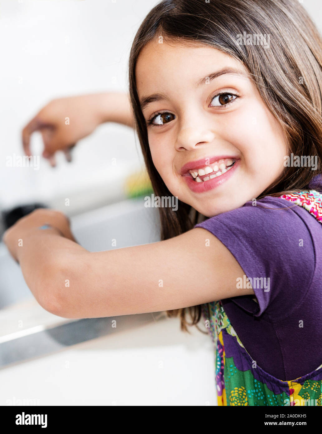Expressive portrait of very cute girl washing hands Stock Photo Alamy
