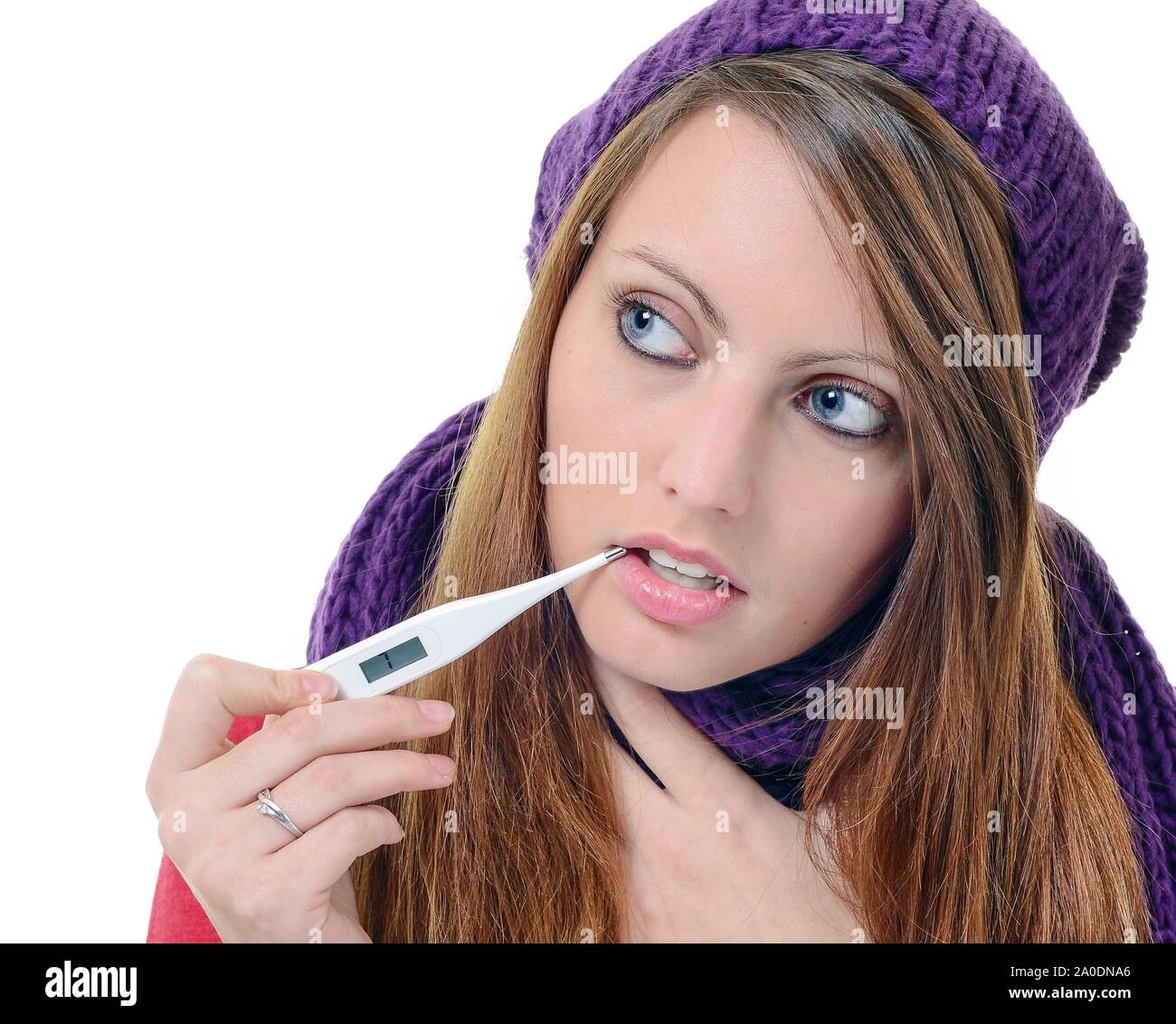 Cute young female using a thermometer in her mouth Stock Photo Alamy