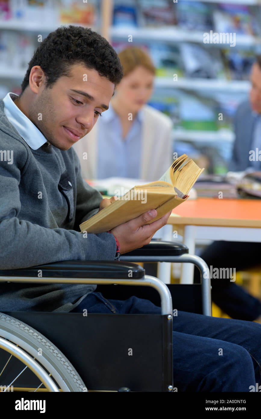physically handicapped man on wheelchair with books Stock Photo Alamy