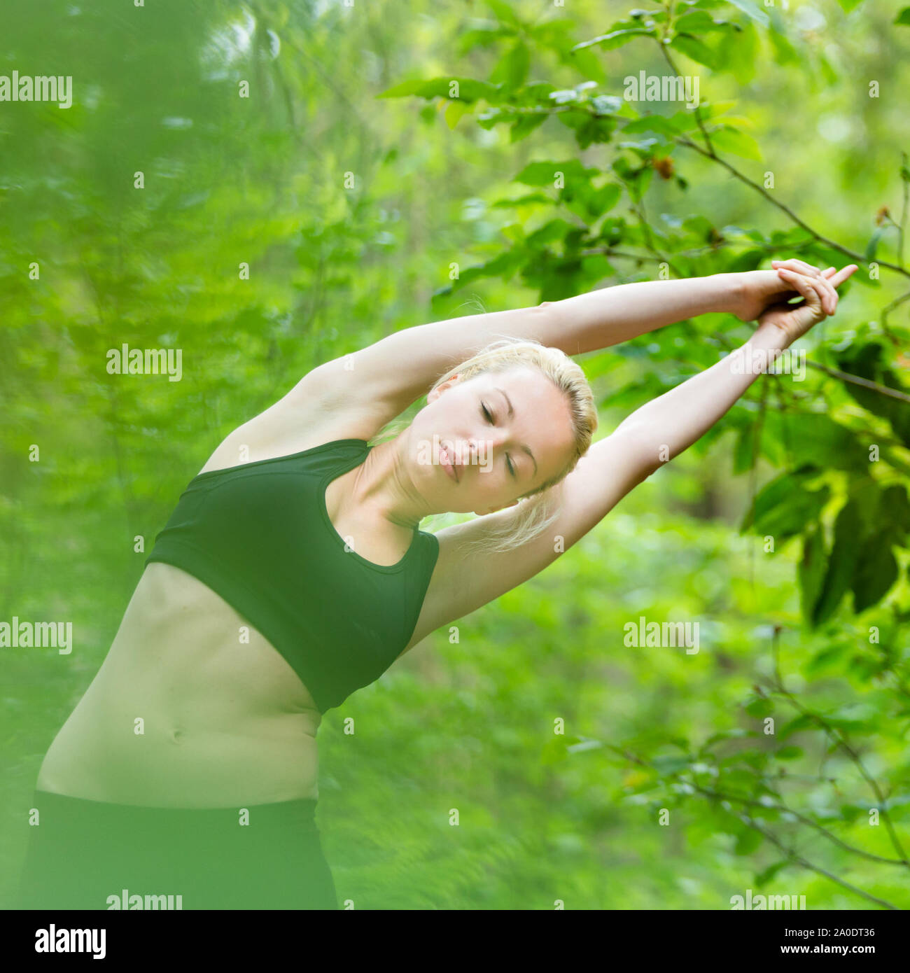Lady practicing yoga in the nature. Stock Photo