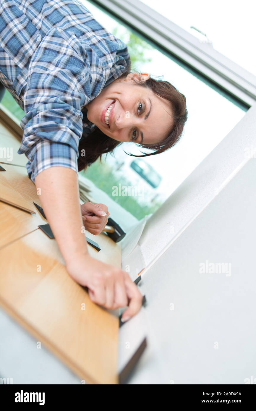 woman carpenter assembling furniture at home Stock Photo