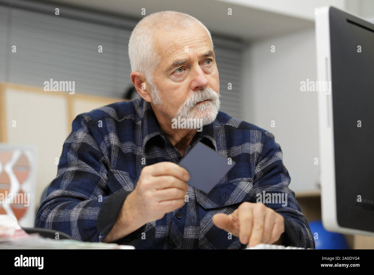 mature man holding color swatch Stock Photo - Alamy