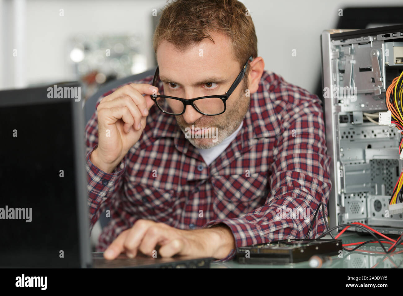 computer repairman on wheelchair working Stock Photo