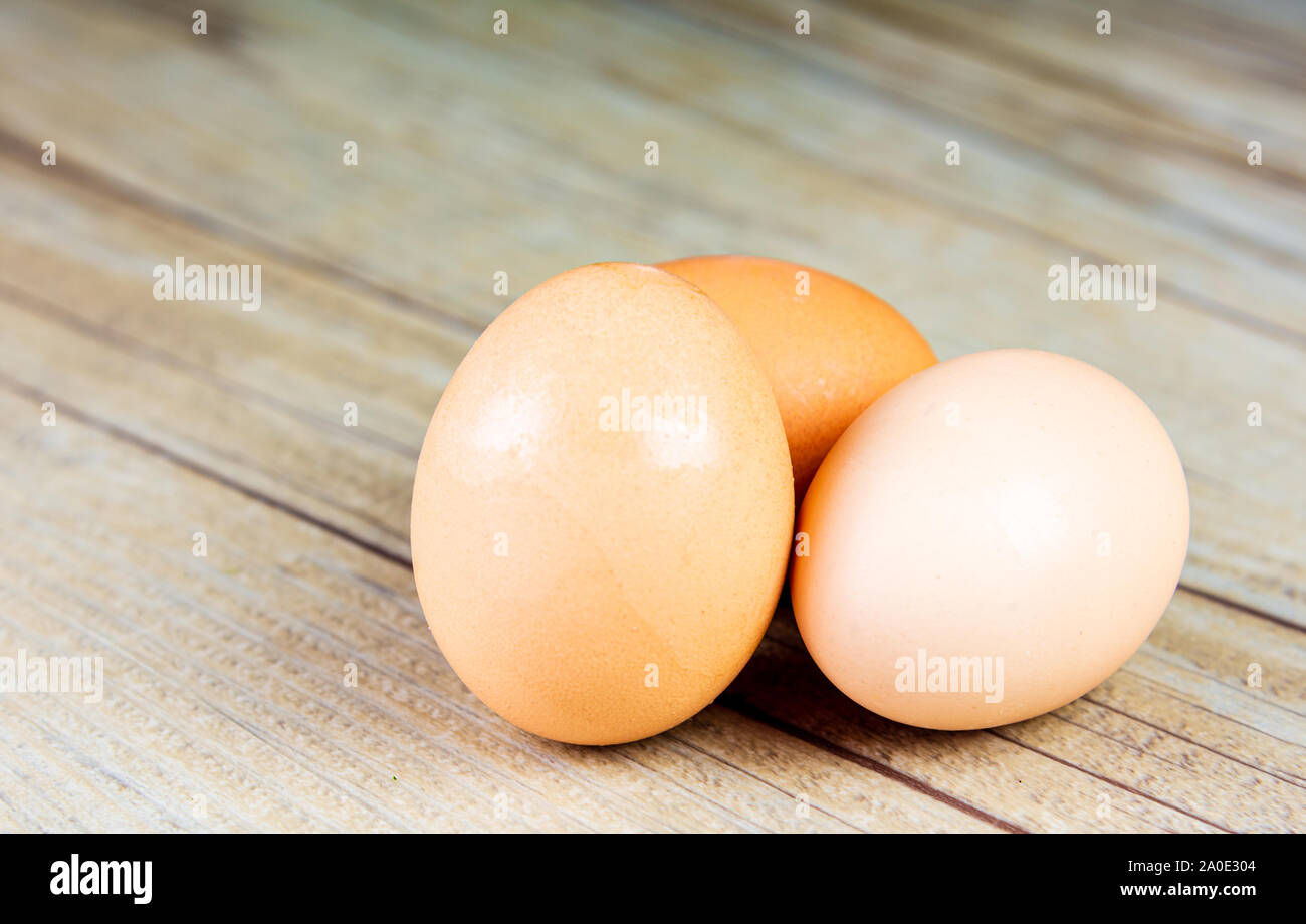 Three Eggs on a Wooden Background Stock Photo