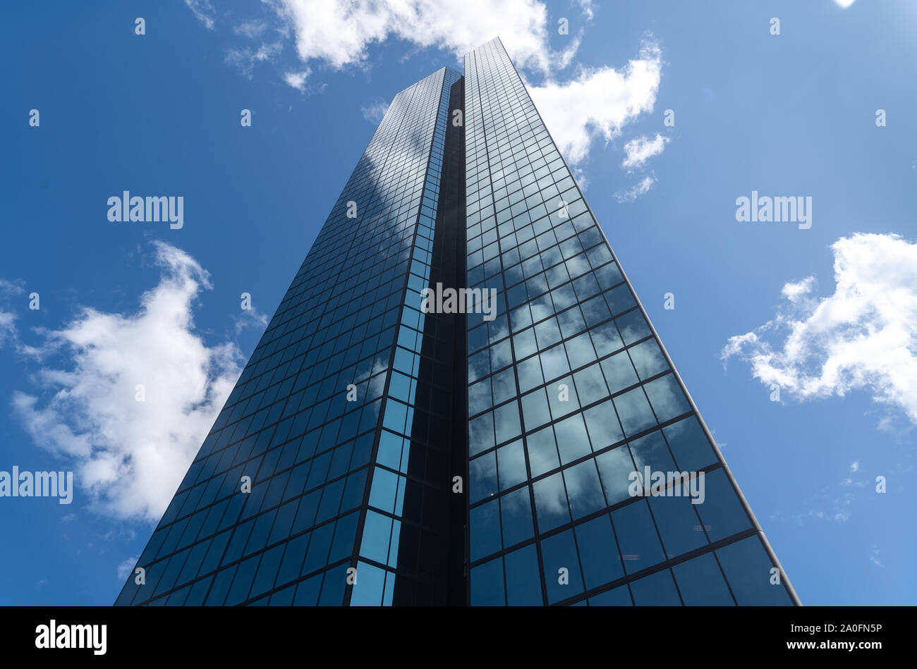 Boston Skyscraper with glass windows and blue cloudy sky reflection ...