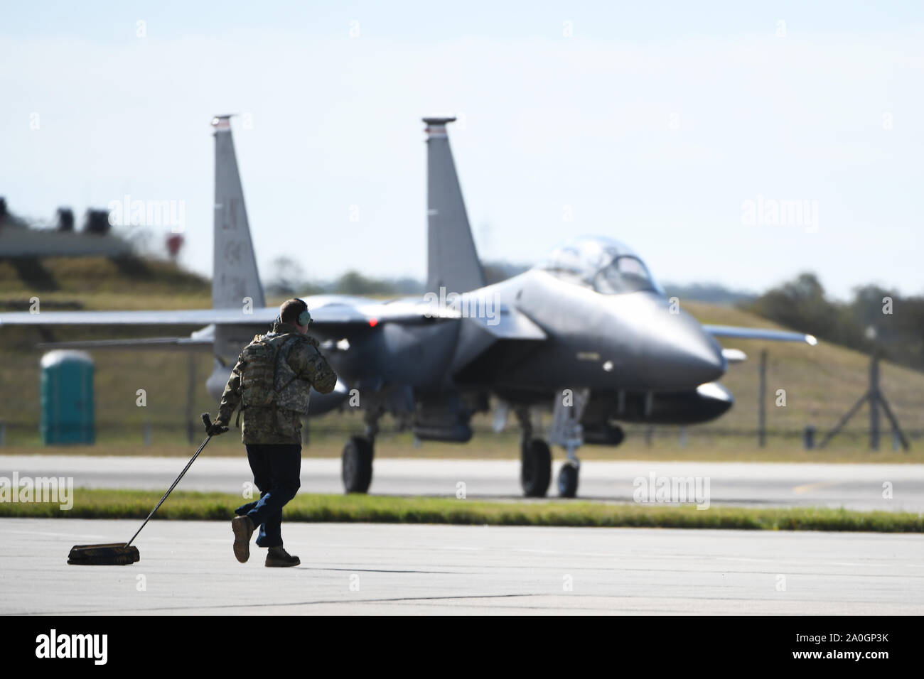 A crew chief assigned to the 48th Fighter Wing approaches an F-15E Strike Eagle assigned to the 494th Fighter Squadron on the flightline at Royal Air Force Mildenhall, England, Sept. 12, 2019. Airmen from the 48th FW participated in a Forward Arming and Refueling Point exercise alongside the 352nd Special Operations Wing and 100th Air Refueling Wing to build upon the relationships and integration between missions among different forces. (U.S. Air Force photo by Airman 1st Class Shanice Williams-Jones) Stock Photo