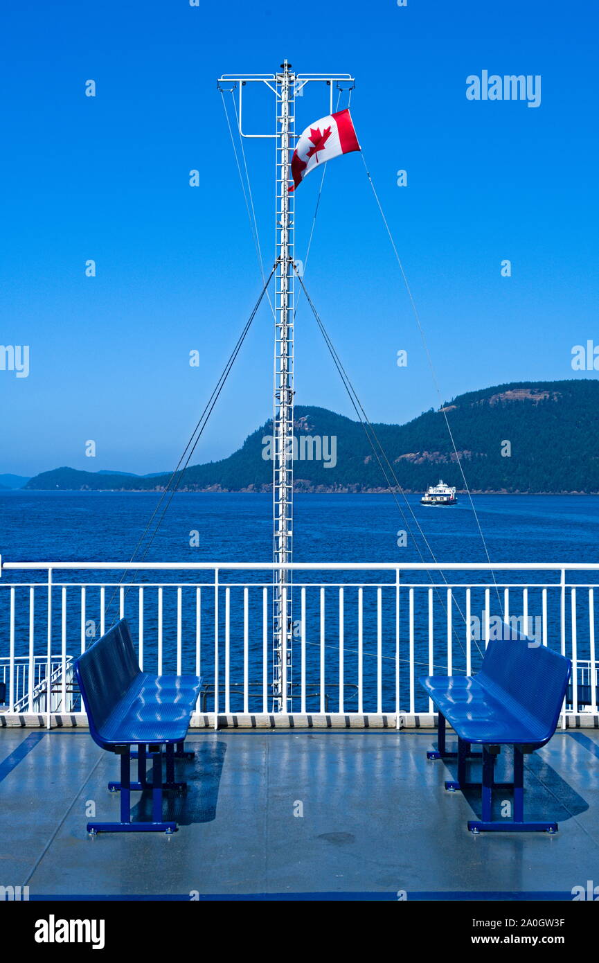 The Canadian flag flying on the bow of BC Ferries Stock Photo