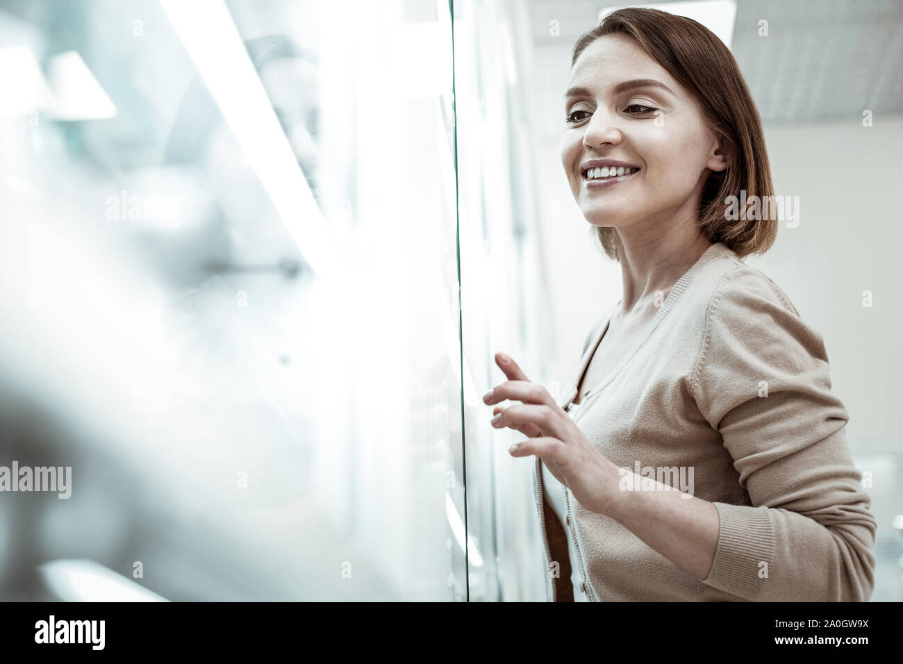 A picky lady indicating the required medicine in the drugstore. Stock Photo